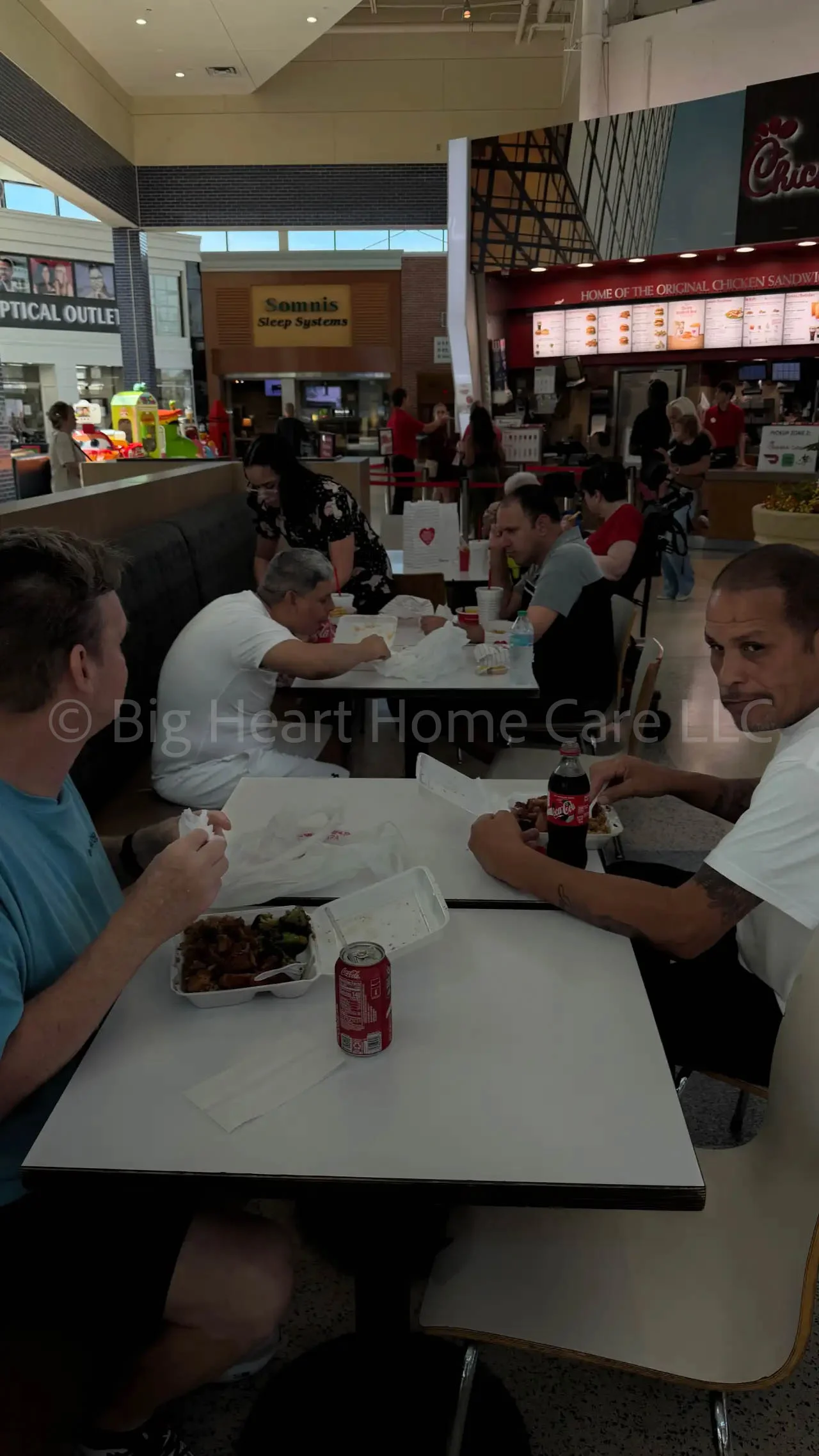Big Heart Group Home residents and staff enjoying a meal together at the food court inside Citrus Park Town Center Mall in Tampa, Florida.