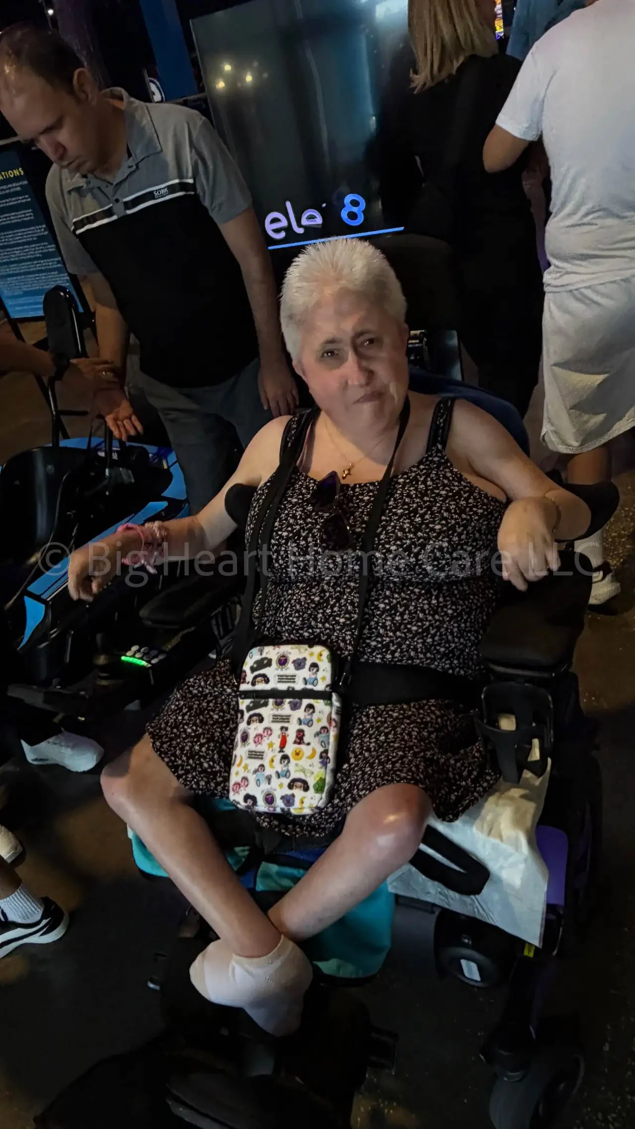 Big Heart Group Home resident seated in a power wheelchair during a community outing at ELEV8 Fun Tampa in Tampa, Florida, confidently looking toward the camera.