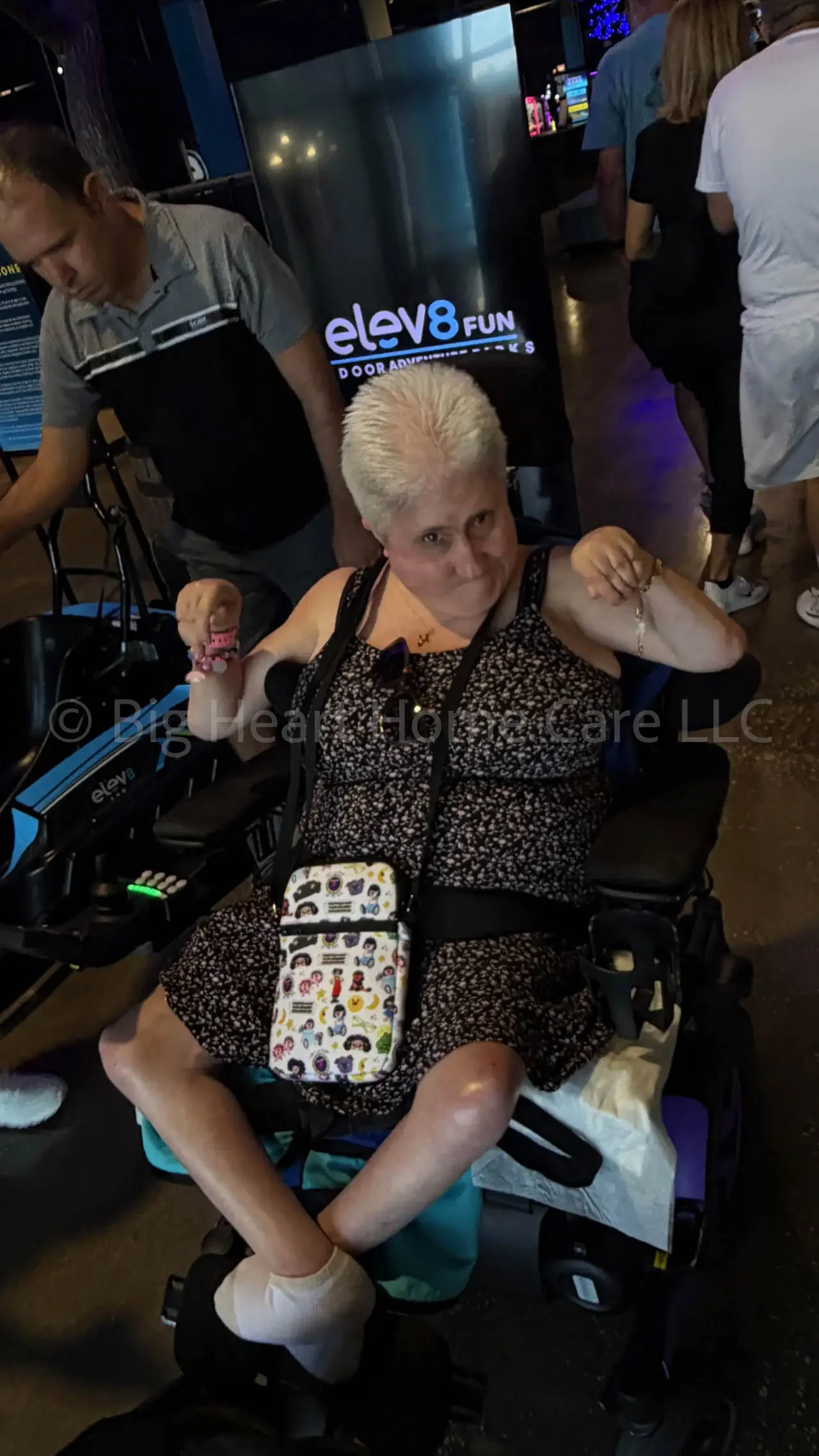Big Heart Group Home resident in a power wheelchair confidently posing during a community outing at ELEV8 Fun Tampa in Tampa, Florida.